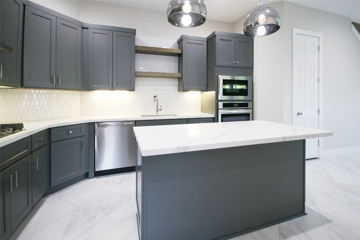 5113 Hershe Street, Unit B Houston, TX 77020 - Photo 10 of 44 a kitchen with stainless steel appliances a sink stove and cabinets