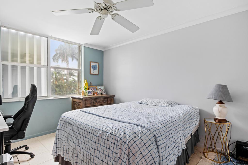 2860 South Ocean Boulevard, Unit 208 Palm Beach, FL 33480 - Photo 11 of 18 a bedroom with a bed a desk and chair with window