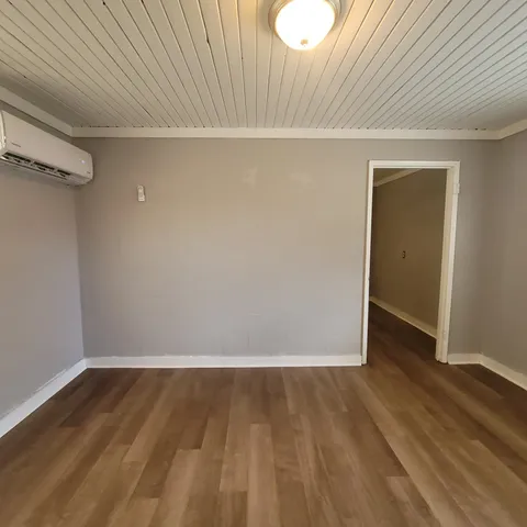 a view of a room with wooden floor