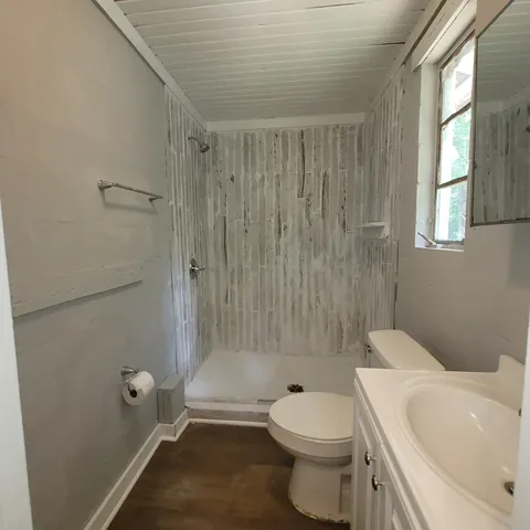 a white toilet sitting next to a bath tub shower