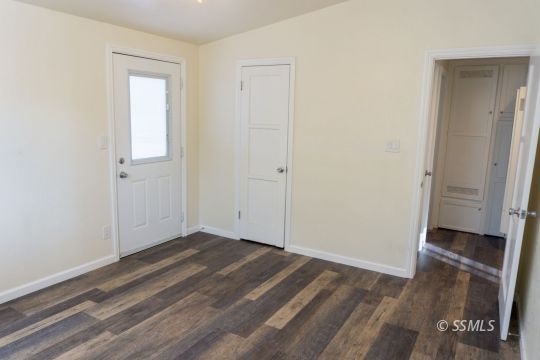 309 North Florence Street Ridgecrest, CA 93555 - Photo 23 of 31 an empty room with wooden floor and a bathroom