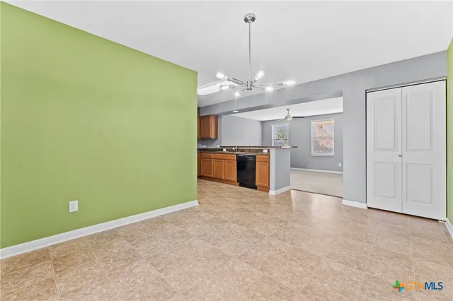 a kitchen with stainless steel appliances granite countertop a stove a sink dishwasher a refrigerator and a microwave oven