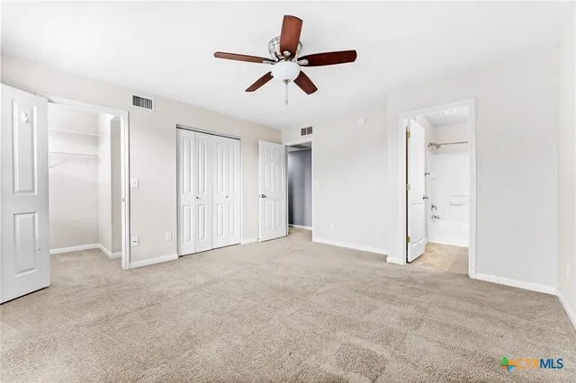 a bathroom with a sink a toilet a mirror a bathtub and shower