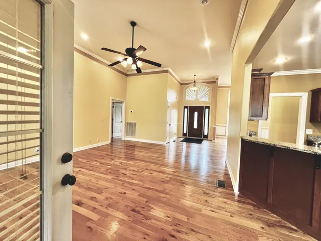 a kitchen with granite countertop a refrigerator and a sink