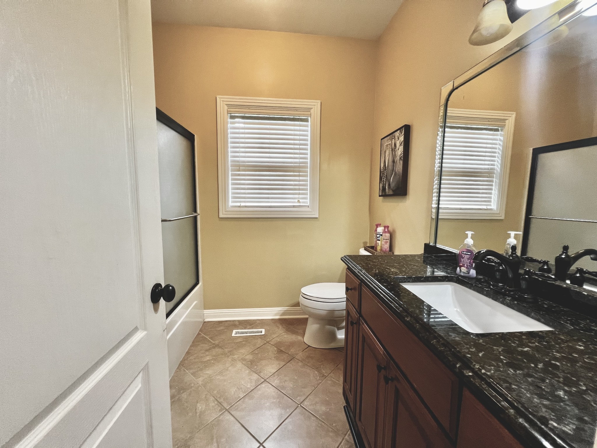 102 Spring View Place Cottontown, TN 37048 - Photo 26 of 40 a bathroom with a granite countertop sink toilet and mirror