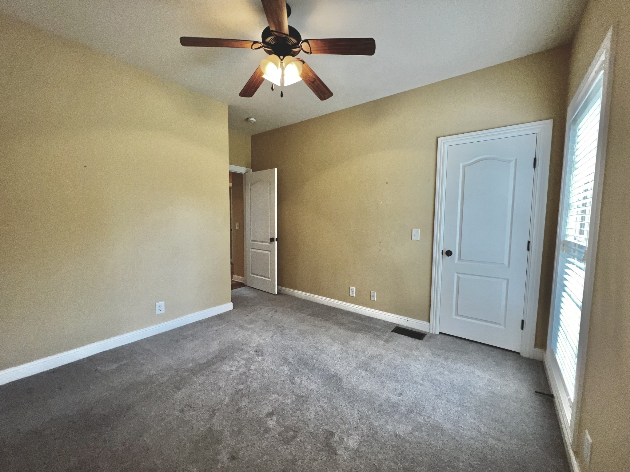 102 Spring View Place Cottontown, TN 37048 - Photo 7 of 40 an empty room with a chandelier fan and a ceiling fan