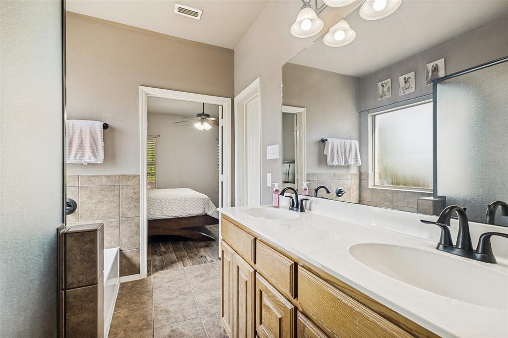 1 Pleasant Valley Sanger, TX 76266 - Photo 18 of 37 Master bathroom with dual sinks and large frosted window to let in natural light.