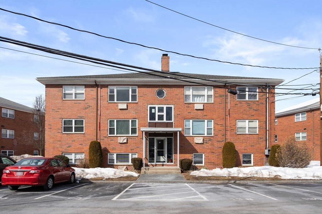 31 Warren Street, Unit B1 Waltham, MA 02453 - Photo 16 of 22 a front view of a building with a road