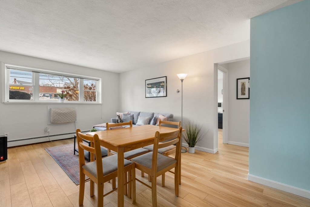 31 Warren Street, Unit B1 Waltham, MA 02453 - Photo 4 of 22 a view of a dining room with furniture and wooden floor