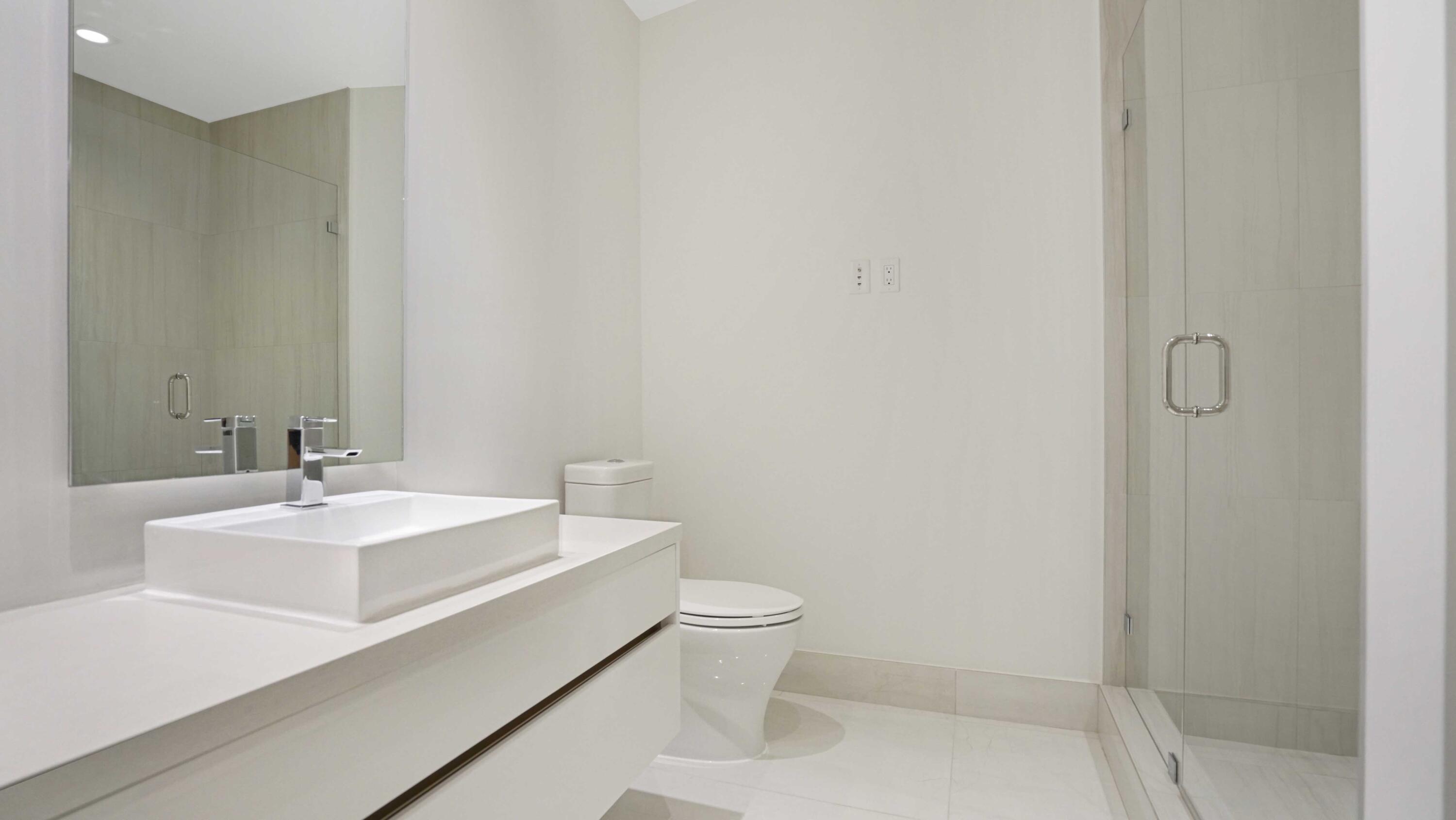 155 East Boca Raton Road, Unit 620 Boca Raton, FL 33432 - Photo 21 of 79 a bathroom with a sink a toilet and a mirror