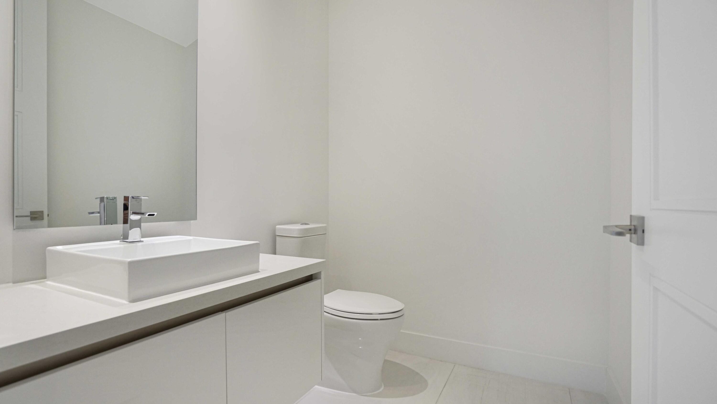 155 East Boca Raton Road, Unit 620 Boca Raton, FL 33432 - Photo 23 of 79 a bathroom with a sink a toilet and mirror