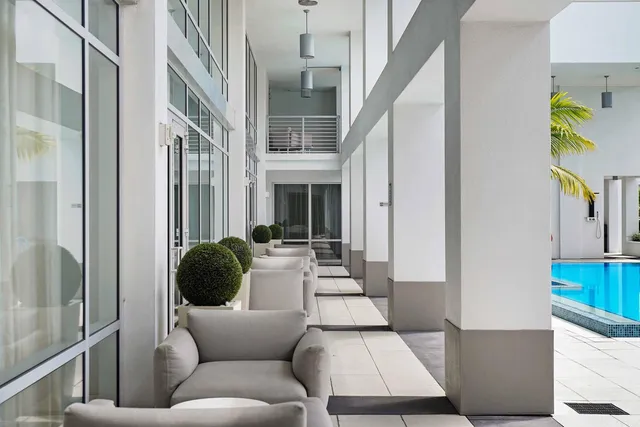 a view of a patio with couches and potted plants