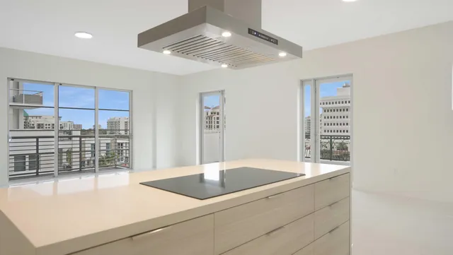 a kitchen with a stove cabinets and chandelier