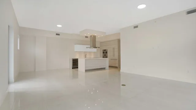 a kitchen with stainless steel appliances granite countertop a sink and a refrigerator