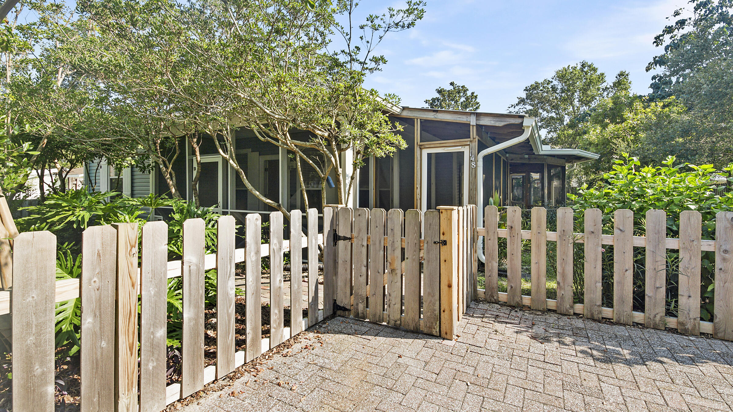 148 Ash Street Santa Rosa Beach, FL 32459 - Photo 1 of 41 a front view of white house with a small yard