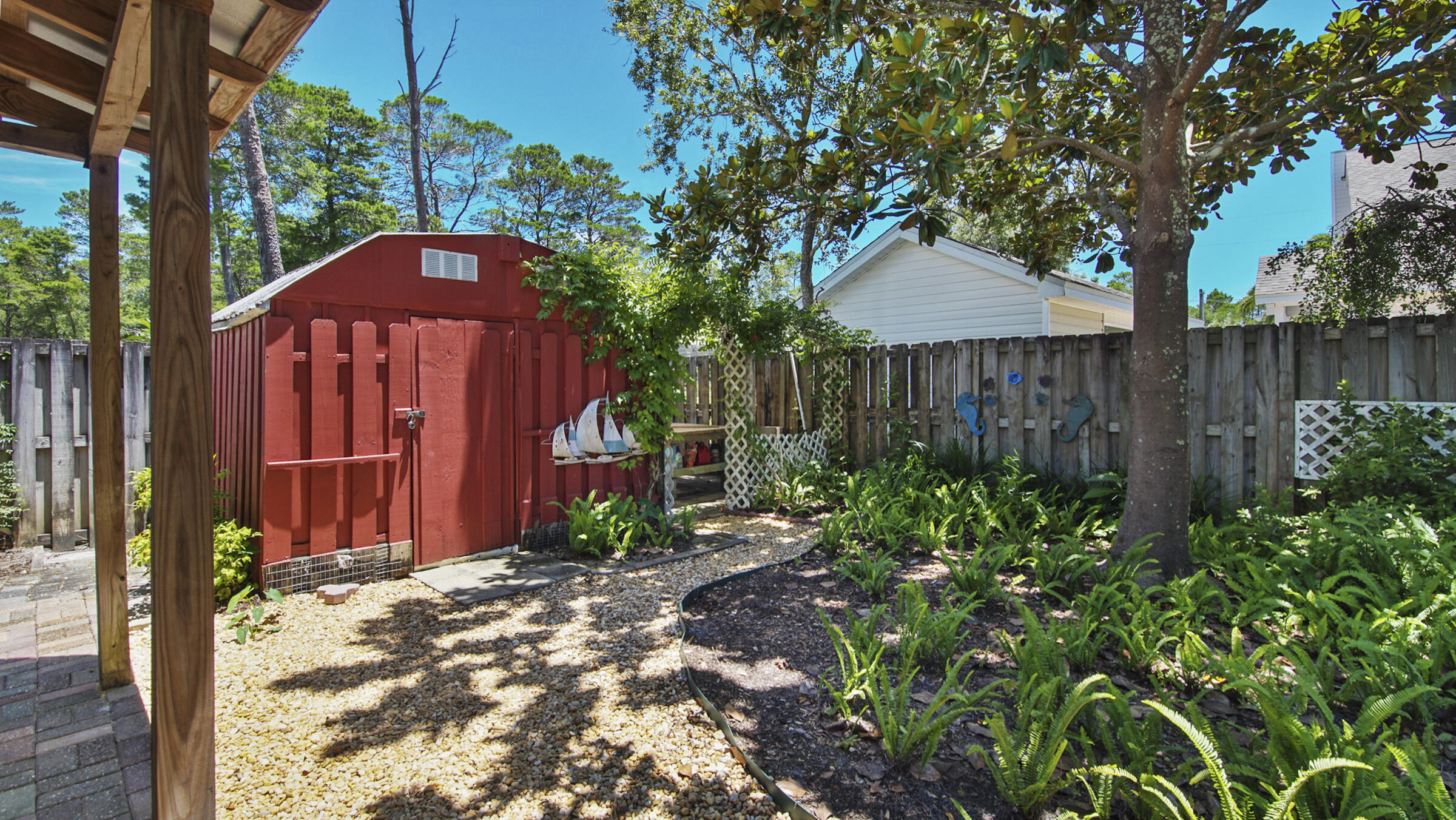 148 Ash Street Santa Rosa Beach, FL 32459 - Photo 15 of 41 a view of a backyard with plants and a large tree