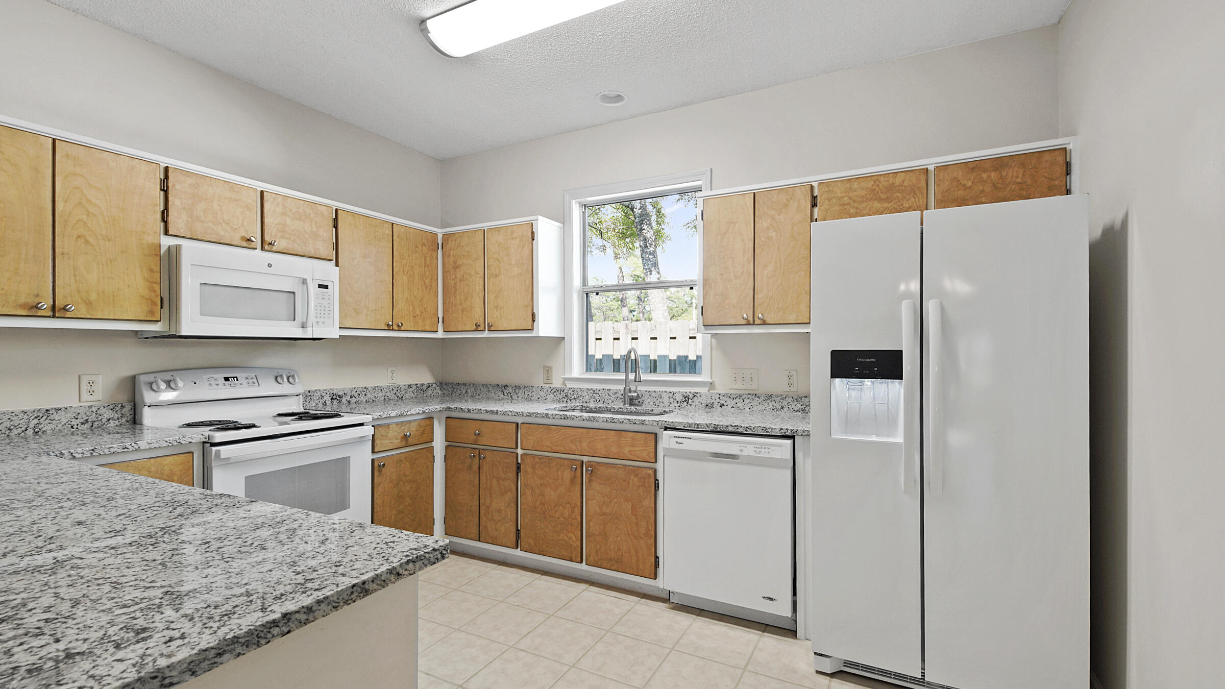 148 Ash Street Santa Rosa Beach, FL 32459 - Photo 21 of 41 a kitchen with stainless steel appliances granite countertop a sink and cabinets