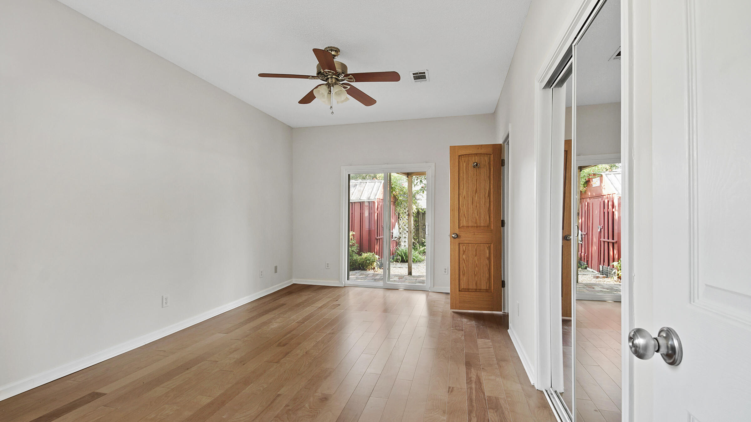148 Ash Street Santa Rosa Beach, FL 32459 - Photo 23 of 41 a view of a livingroom with wooden floor and a ceiling fan