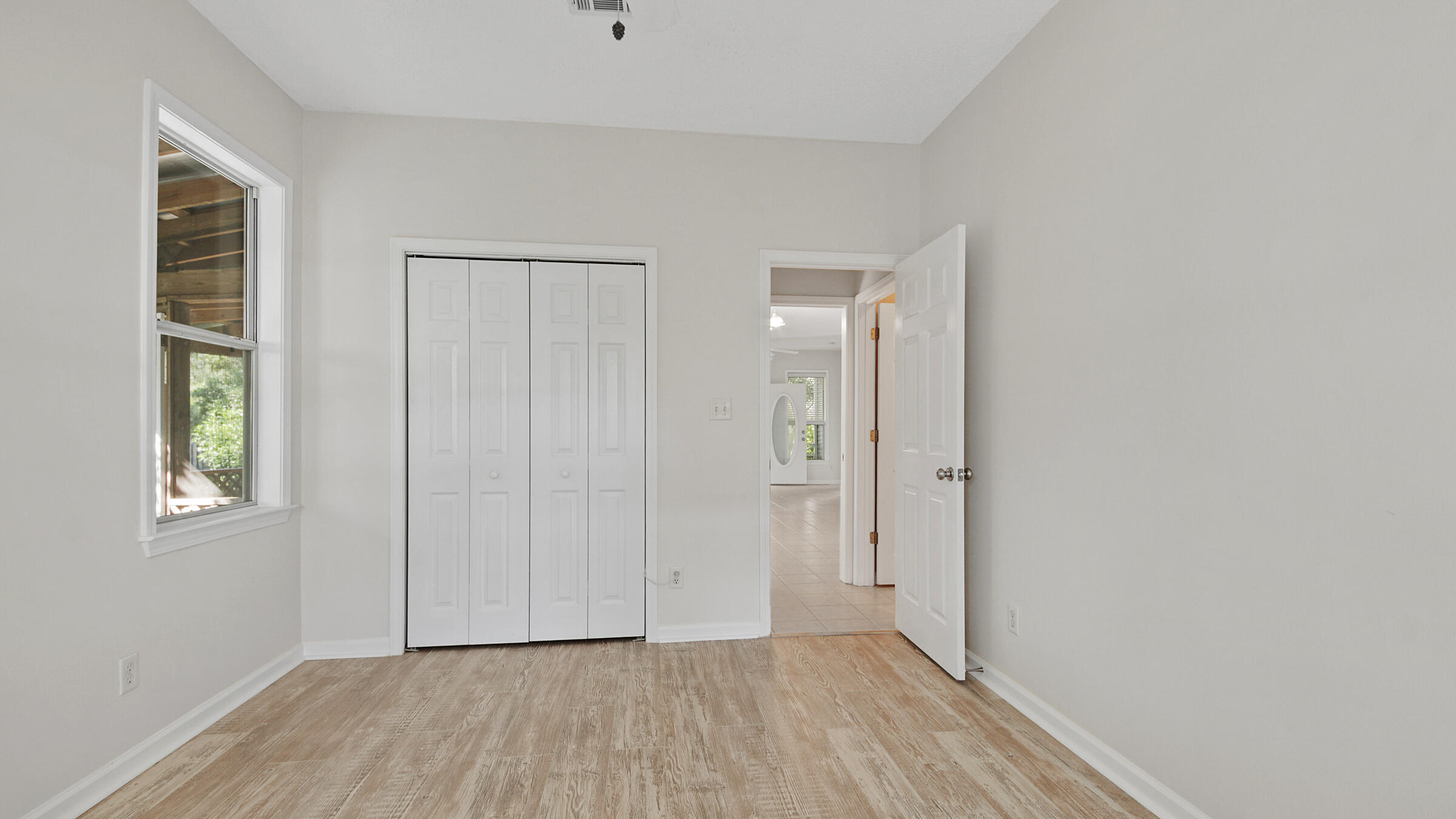 148 Ash Street Santa Rosa Beach, FL 32459 - Photo 29 of 41 a view of an empty room with closet and wooden floor