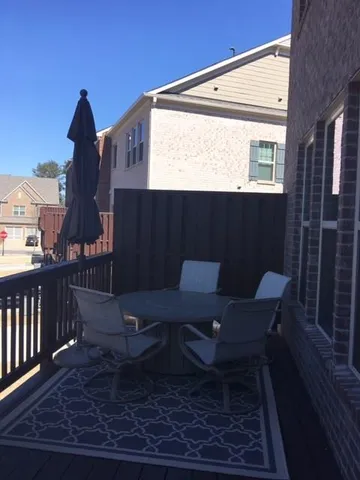 a view of a chairs and table in patio