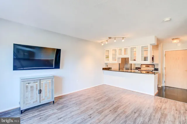 a kitchen with a refrigerator and a stove top oven