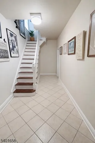 a view of a hallway with closet and stairs