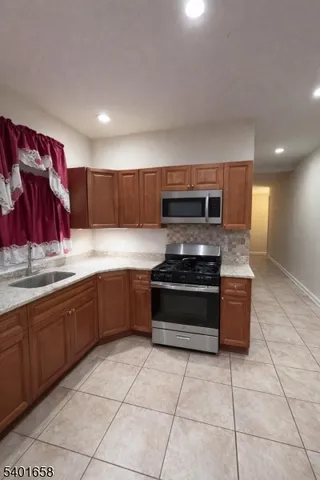 a kitchen with stainless steel appliances granite countertop a stove and a sink