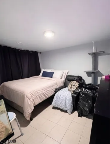 a large bed sitting in a bedroom next to a lamp