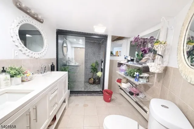 a bathroom with a sink mirror vanity and toilet