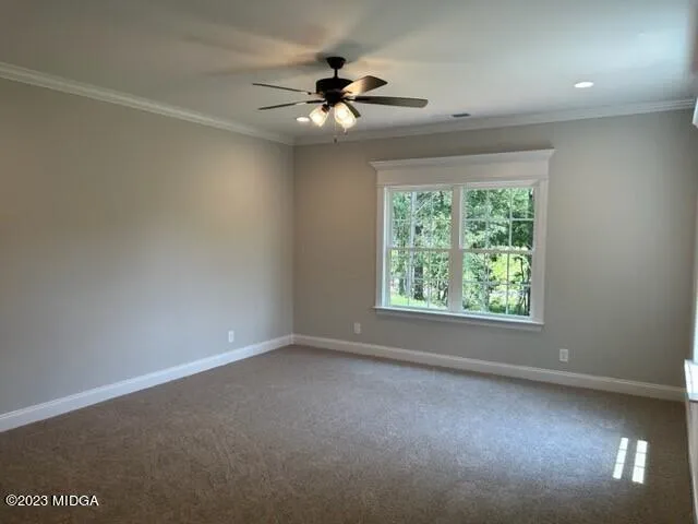 an empty room with a ceiling fan and window