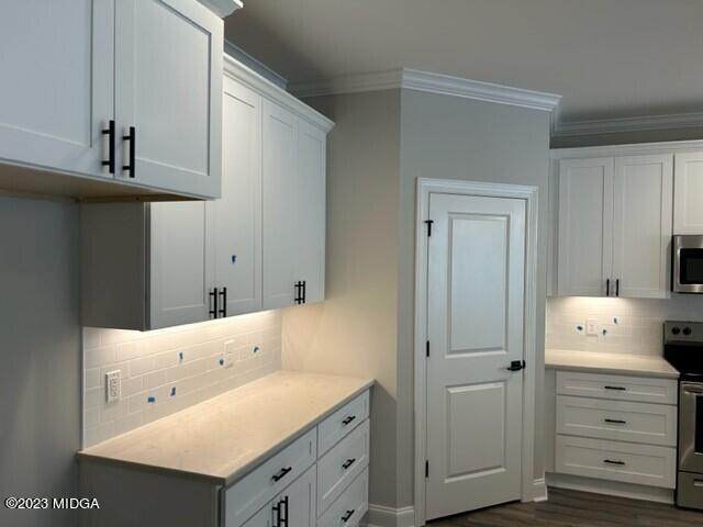 2203 Exchange Drive Macon, GA 31210 - Photo 4 of 16 a room with white cabinets and clock on the wall