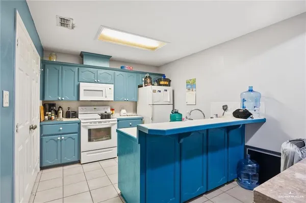 a kitchen with a sink a stove and cabinets