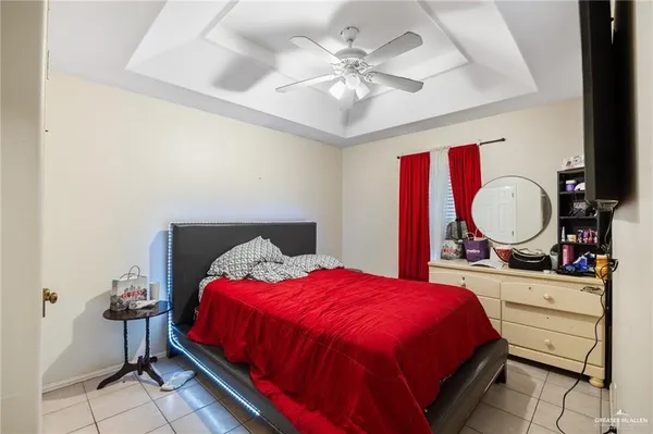 a bed room with a bed mirror and a chandelier