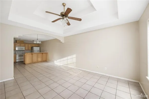 a view of a livingroom with a ceiling fan and wooden floor