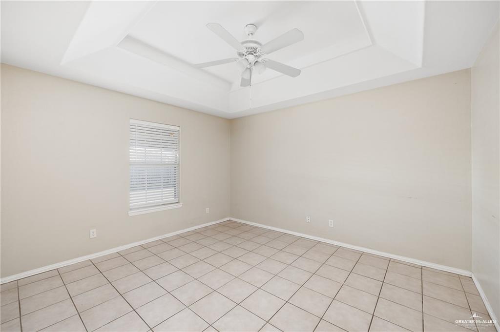 1504 Prosperity Drive, Unit 1 Edinburg, TX 78541 - Photo 5 of 18 an empty room with windows and ceiling fan
