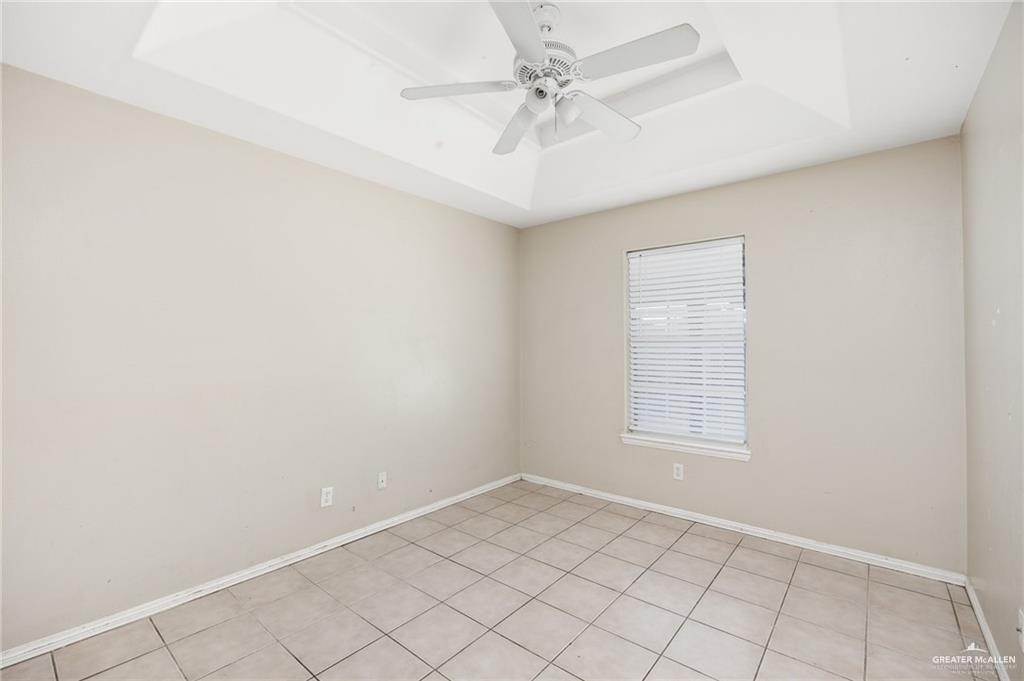 1504 Prosperity Drive, Unit 1 Edinburg, TX 78541 - Photo 7 of 18 an empty room with windows and fan