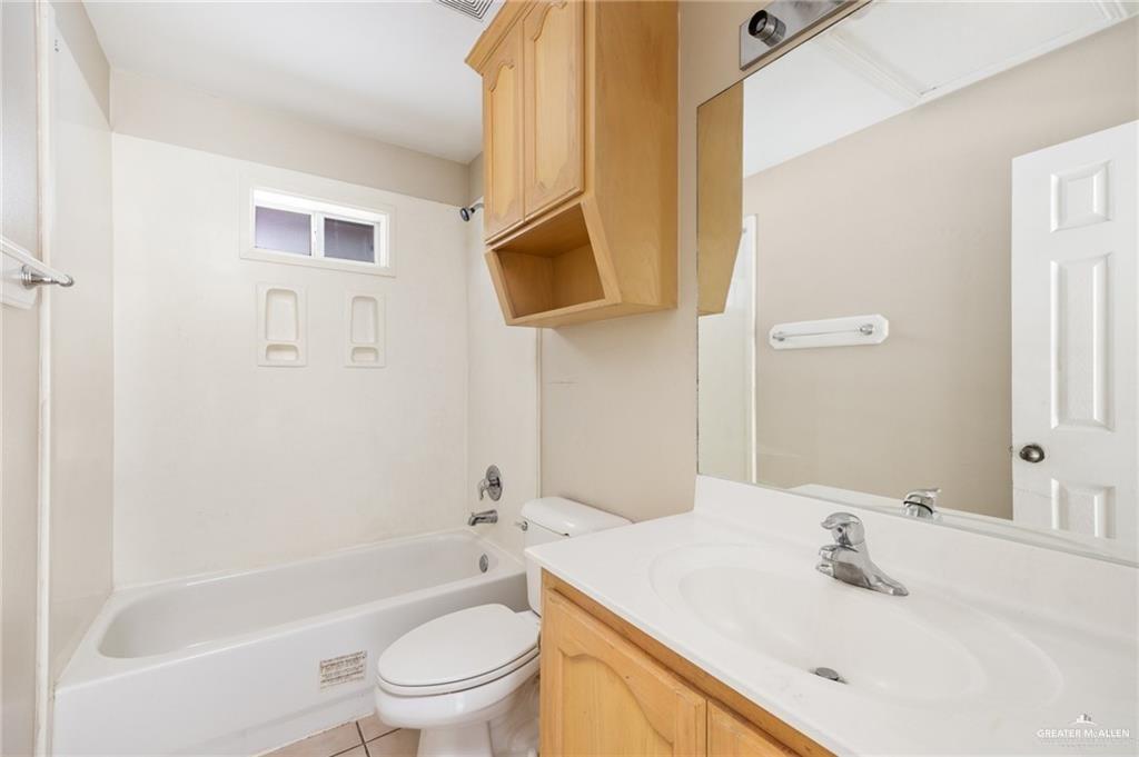 1504 Prosperity Drive, Unit 1 Edinburg, TX 78541 - Photo 8 of 18 a bathroom with a sink a toilet and shower