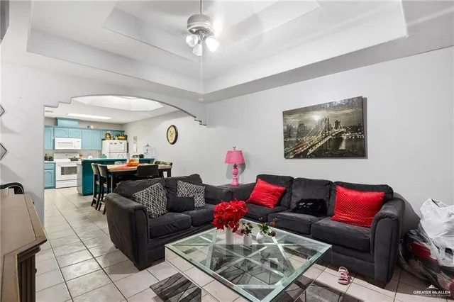 a living room with furniture a rug and a window