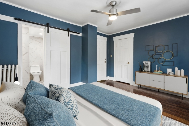 32 Edgewood Road Glen Ridge, NJ 07028 - Photo 14 of 32 a bedroom with a large bed and a chandelier