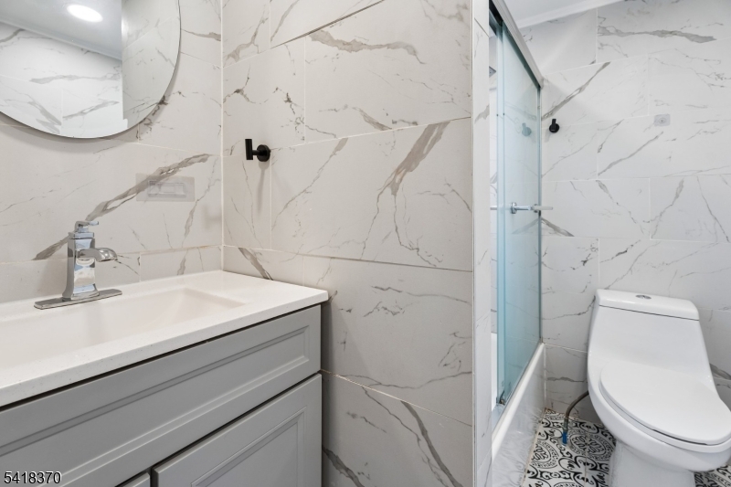 32 Edgewood Road Glen Ridge, NJ 07028 - Photo 15 of 32 a bathroom with a sink a toilet and a mirror