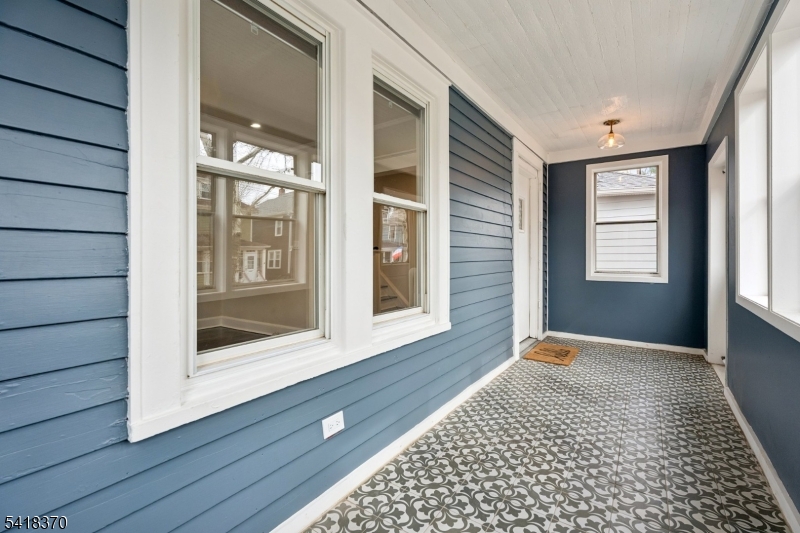 32 Edgewood Road Glen Ridge, NJ 07028 - Photo 4 of 32 a view of an empty room with wooden floor and a window