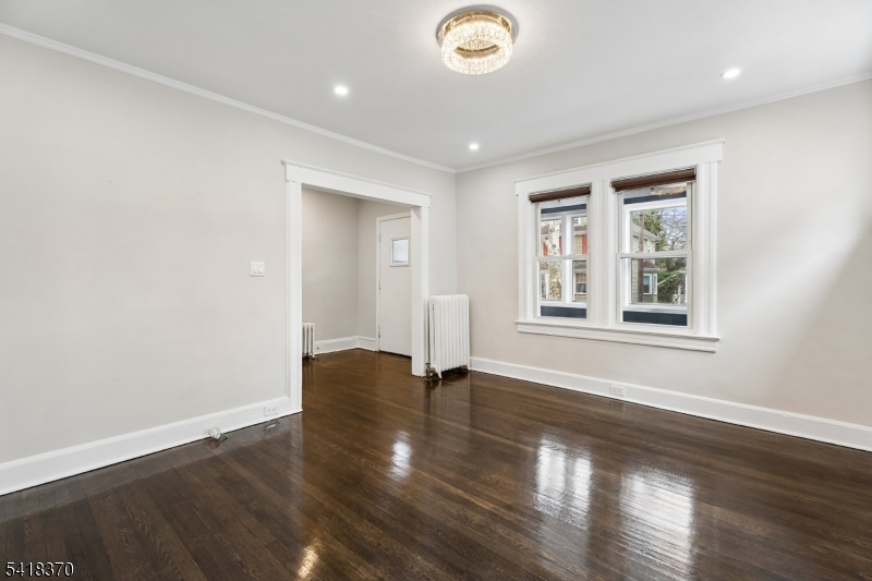 32 Edgewood Road Glen Ridge, NJ 07028 - Photo 8 of 32 a view of an empty room with wooden floor and a window