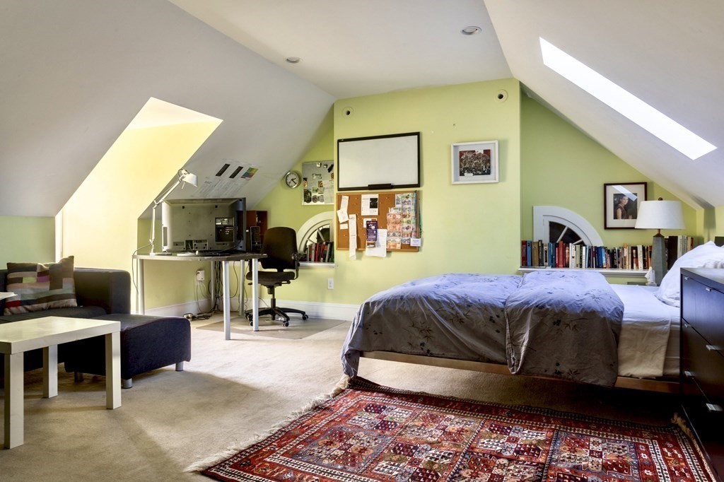 185 Franklin Street Newton, MA 02458 - Photo 20 of 23 a living room with a bed furniture and a flat screen tv