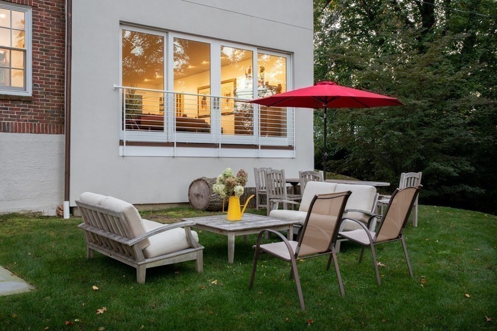 185 Franklin Street Newton, MA 02458 - Photo 22 of 23 a backyard of a house with table and chairs