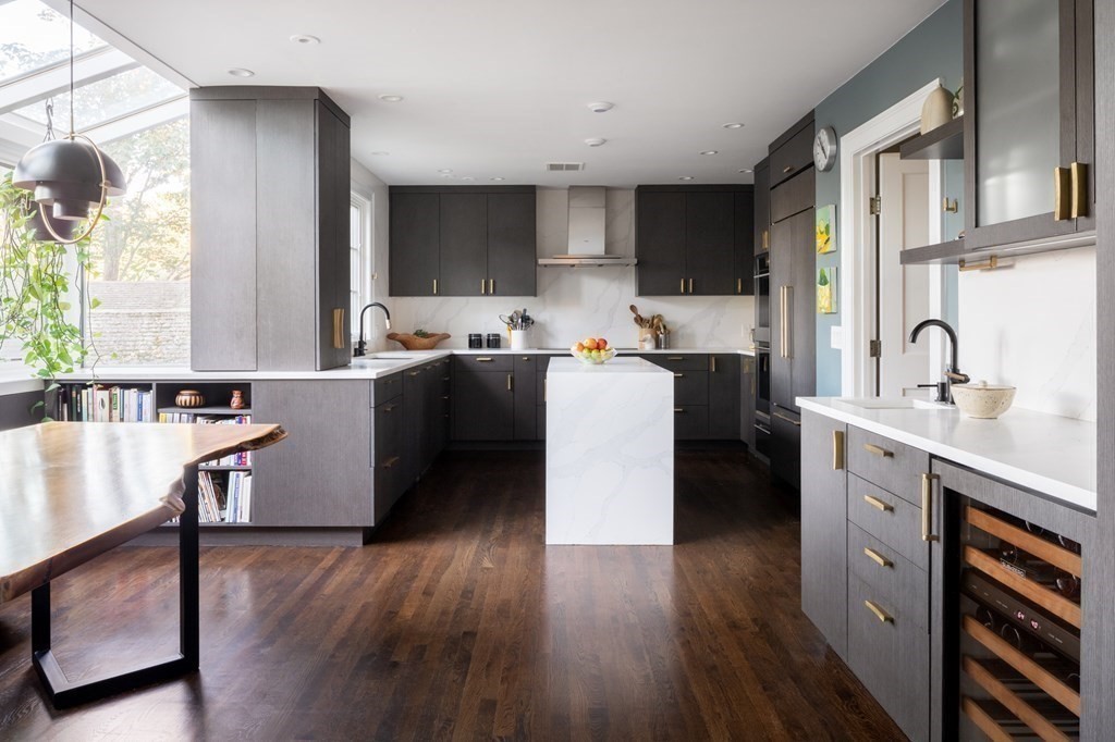 185 Franklin Street Newton, MA 02458 - Photo 8 of 23 a kitchen with stainless steel appliances a stove top oven a sink dishwasher and a refrigerator with wooden floor