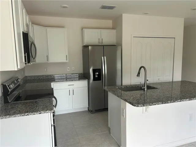 a kitchen with a sink and refrigerator