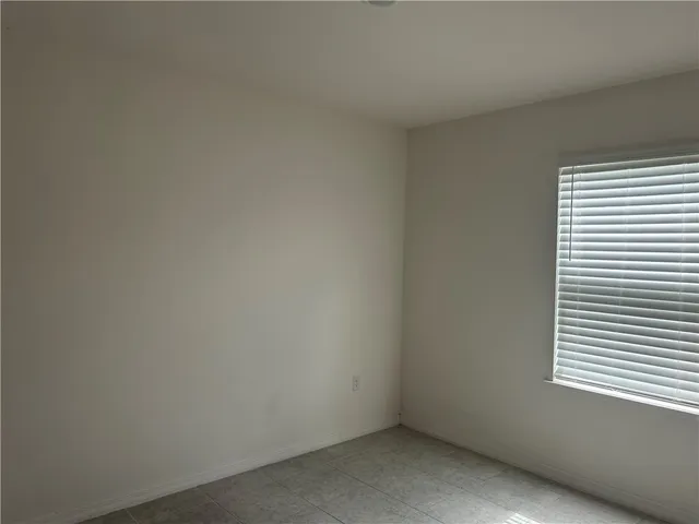 a view of an empty room and a window