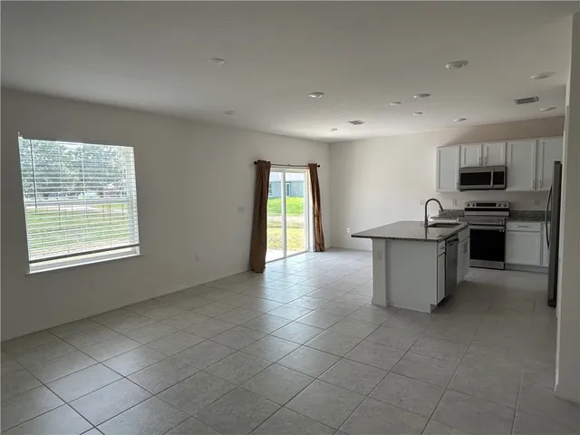 a kitchen with stainless steel appliances a sink stove and microwave