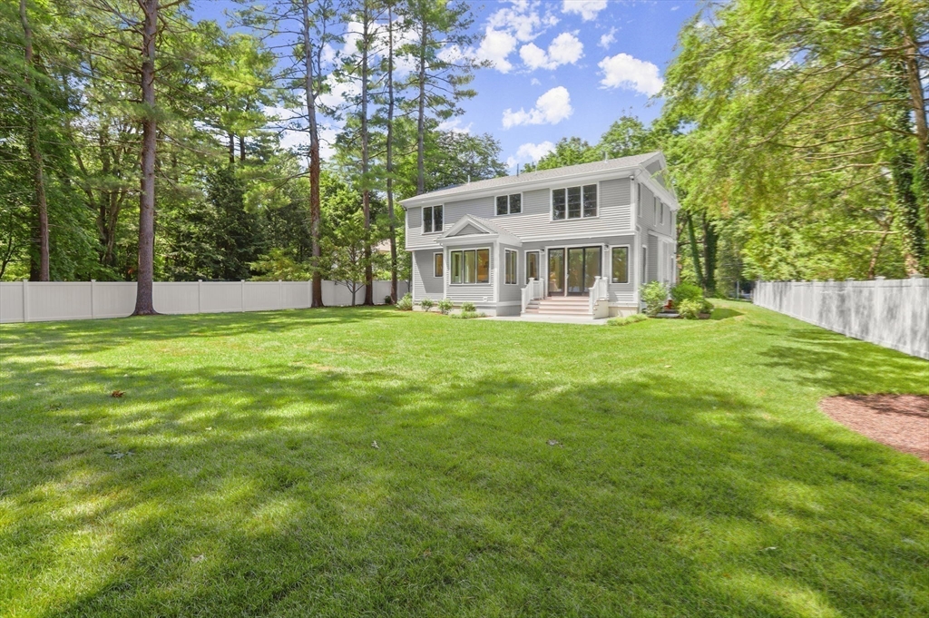 86 Parker Road Wellesley, MA 02482 - Photo 22 of 25 a view of a house with a big yard and large trees