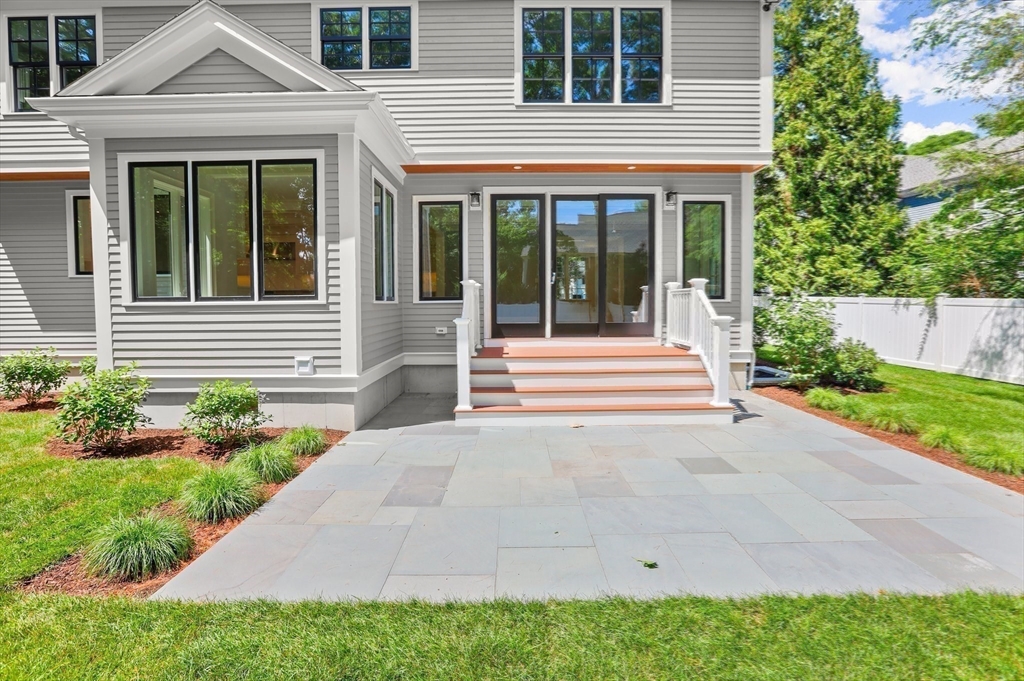 86 Parker Road Wellesley, MA 02482 - Photo 24 of 25 a front view of a house with a yard and potted plants